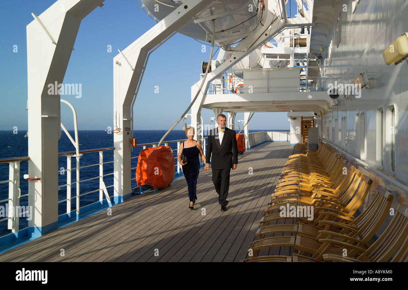 Couple in formal dress walking along the deck of a cruise ship Stock Photo - Alamy Couple in formal dress walking along the deck of a cruise ship Stock Photo - Alamy