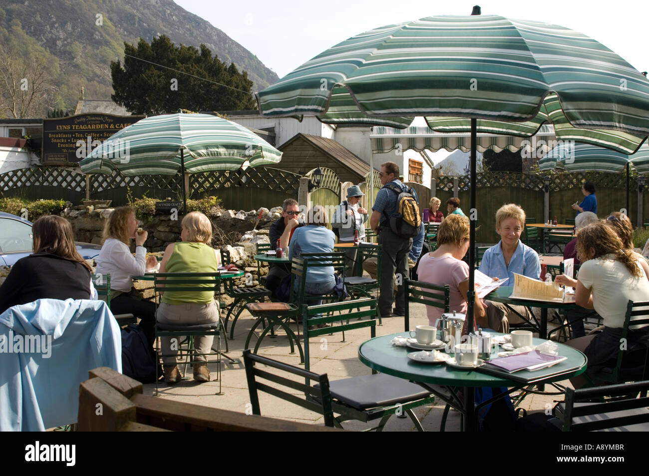 People eating at outdoors cafe Beddgelert snowdonia national park Gwynedd north wales summer afternoon Stock Photo