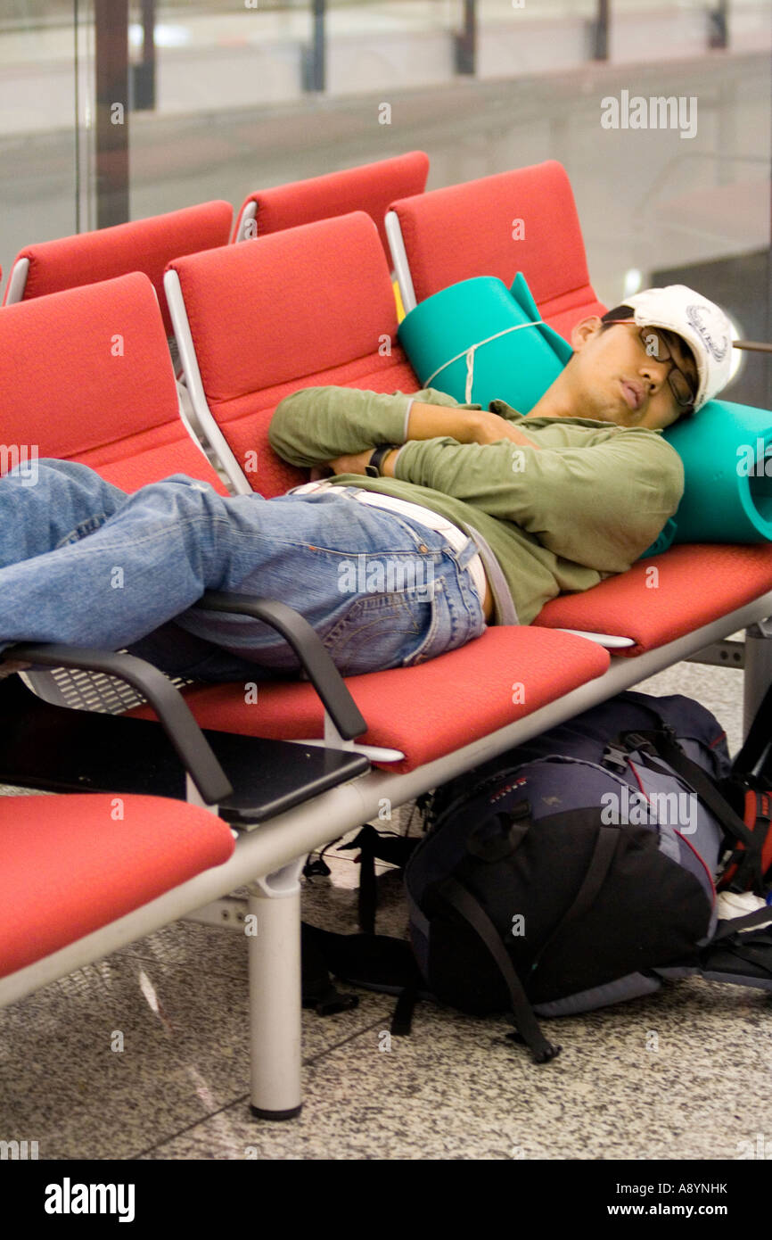 Sleeping at an airport hires stock photography and images Alamy