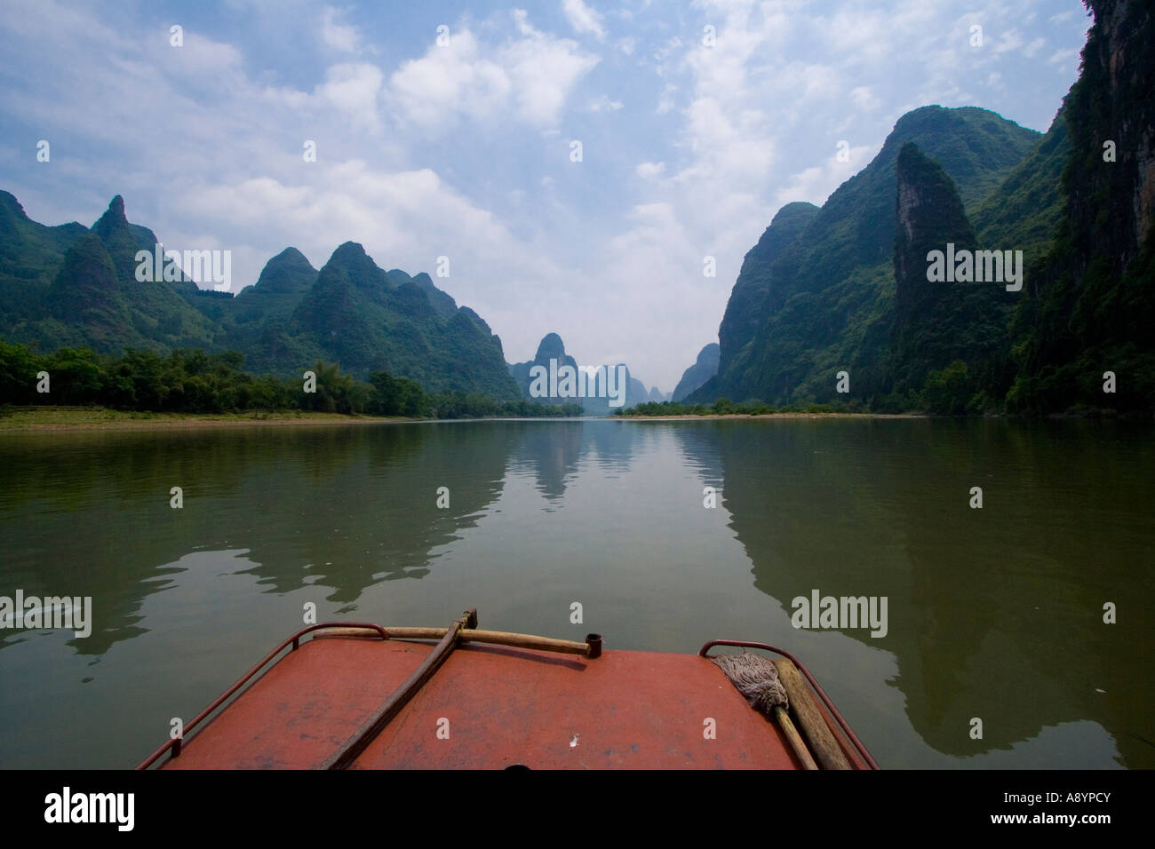 Boat and Distinctive Limestone Karsts Line the Li River in China Stock Photo