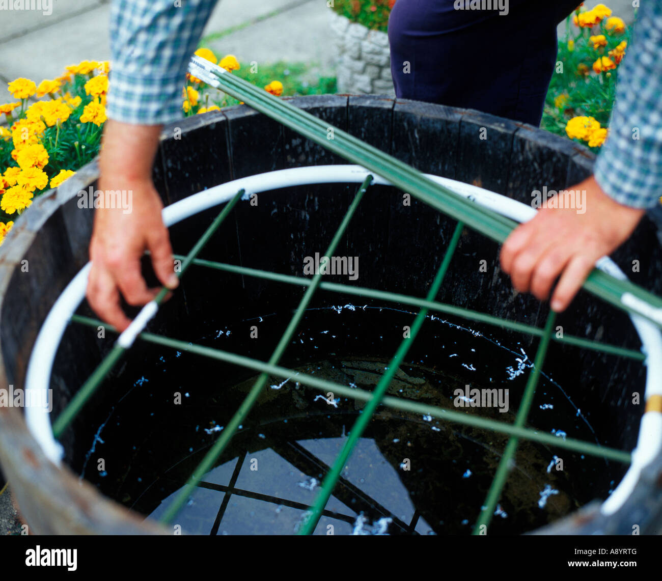 BUILDING A BARREL FEATURE STEP4 ADDING CROSS MEMBERS TO SUPPORT PLANTS AND STONES Stock Photo