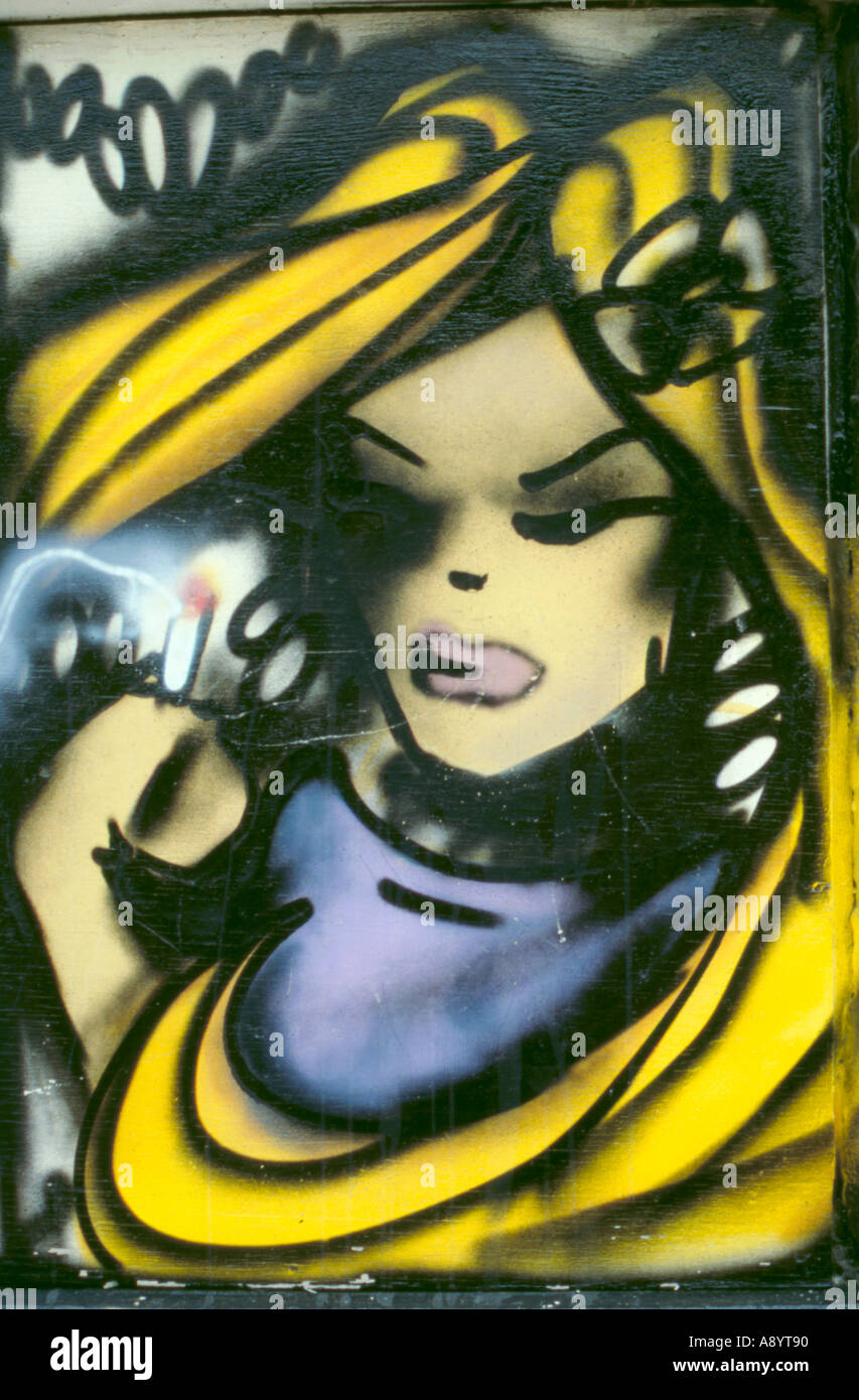 Graffiti spray paint portrait of a girl with blond hair on a hoarding