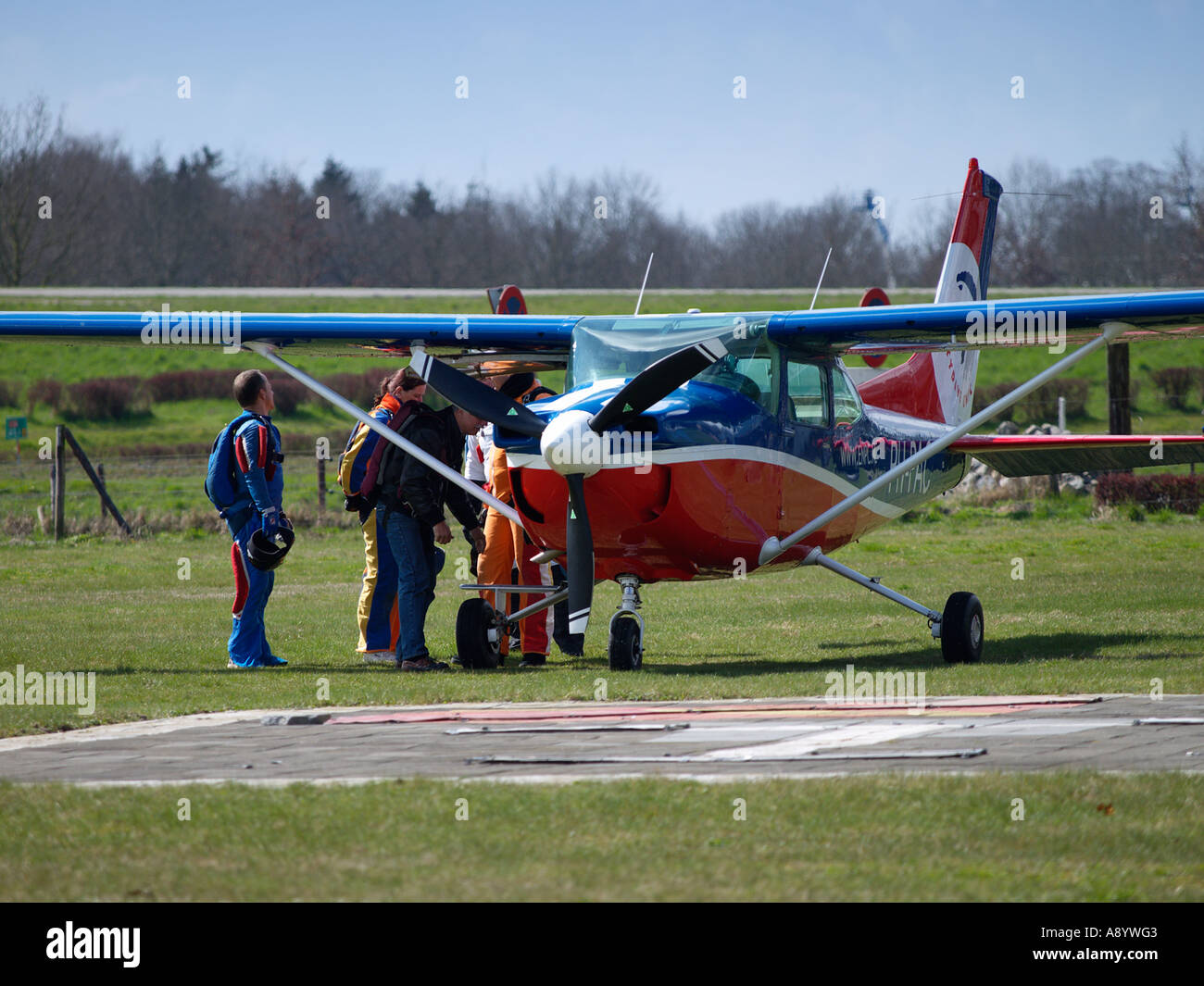 Skydivers gathering round their Cessna aeroplane before takeoff Seppe airfield Noord Brabant the Netherlands Stock Photo