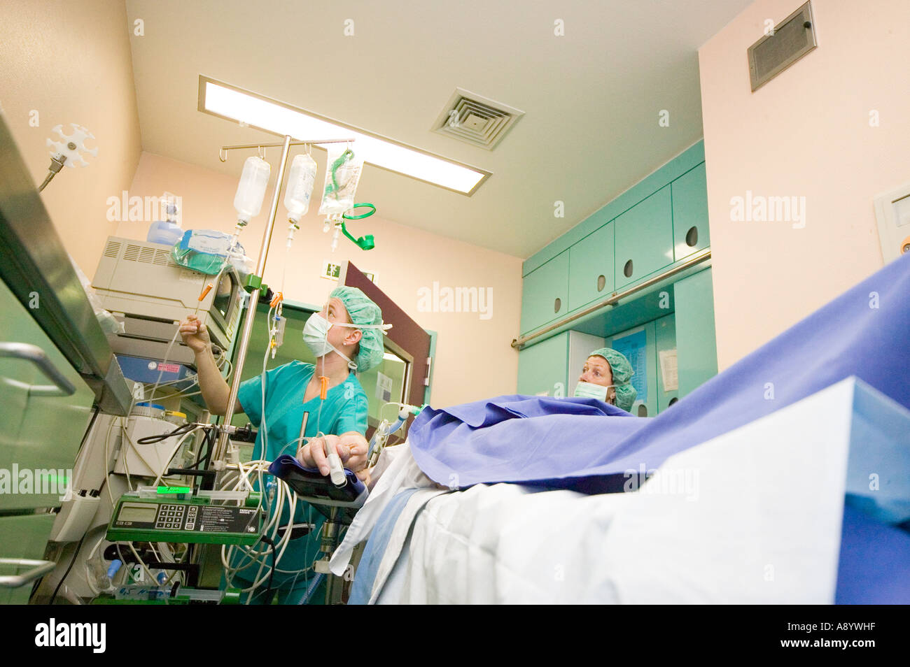 anesthesiologists preparing patient for cancer surgery operating room Stock Photo