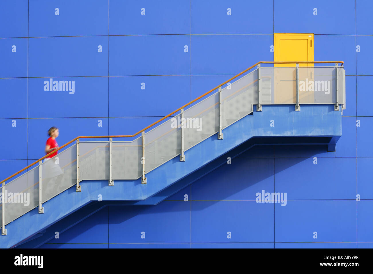 Woman climbing stairs in a colourful scene Stock Photo Alamy