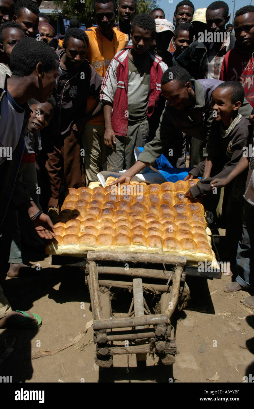 Many people surround fresh bakery on a barrow market of Boditti