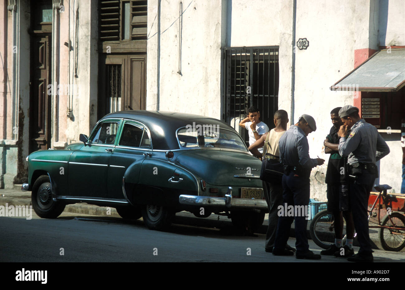 Police checking I D Chinatown area Havana Cuba Stock Photo