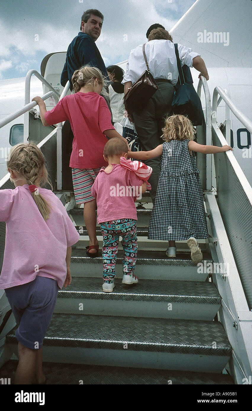 family boarding the stairs into a plane Stock Photo Alamy