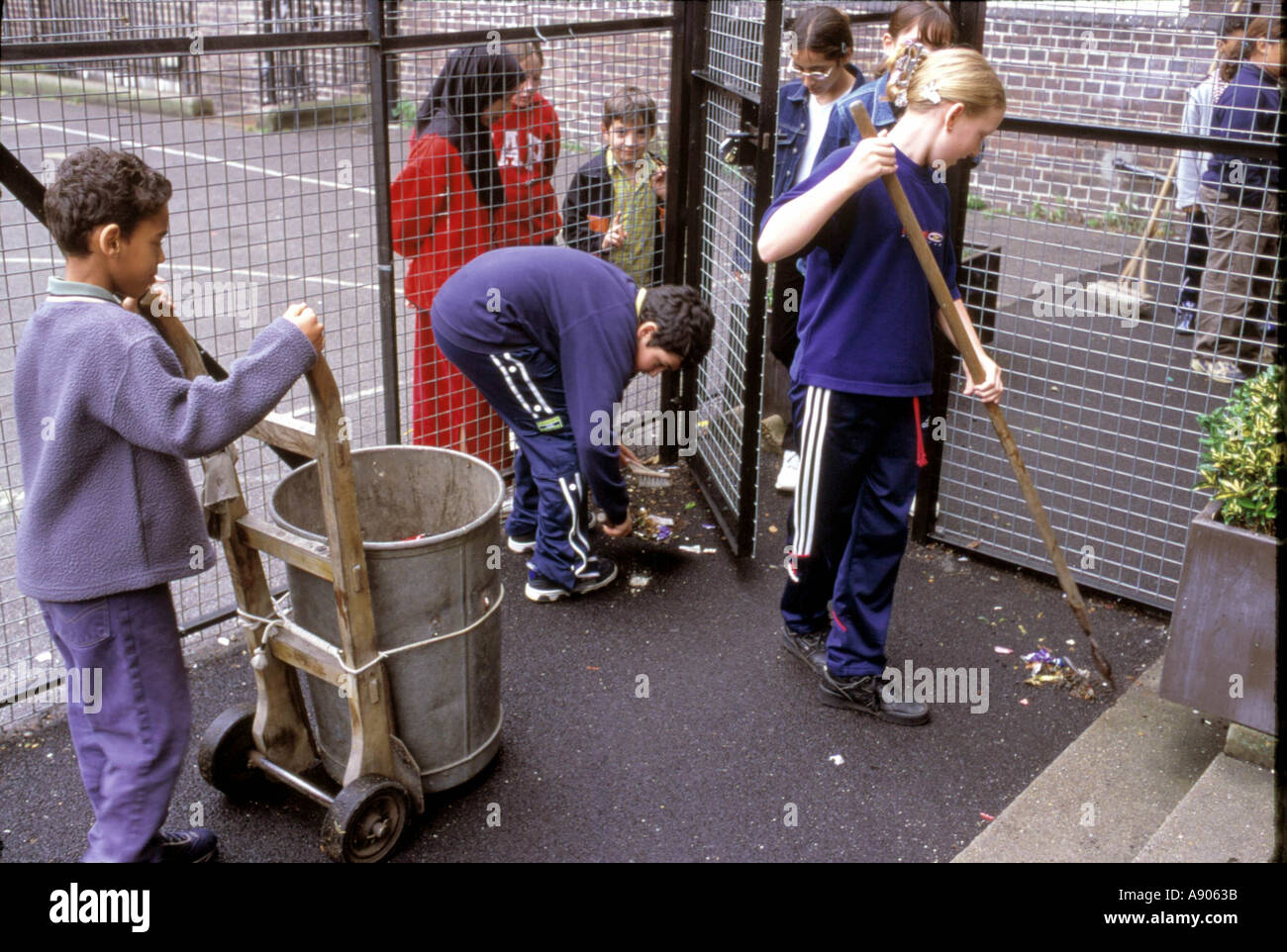 Children cleaning up school playground Stock Photo Alamy