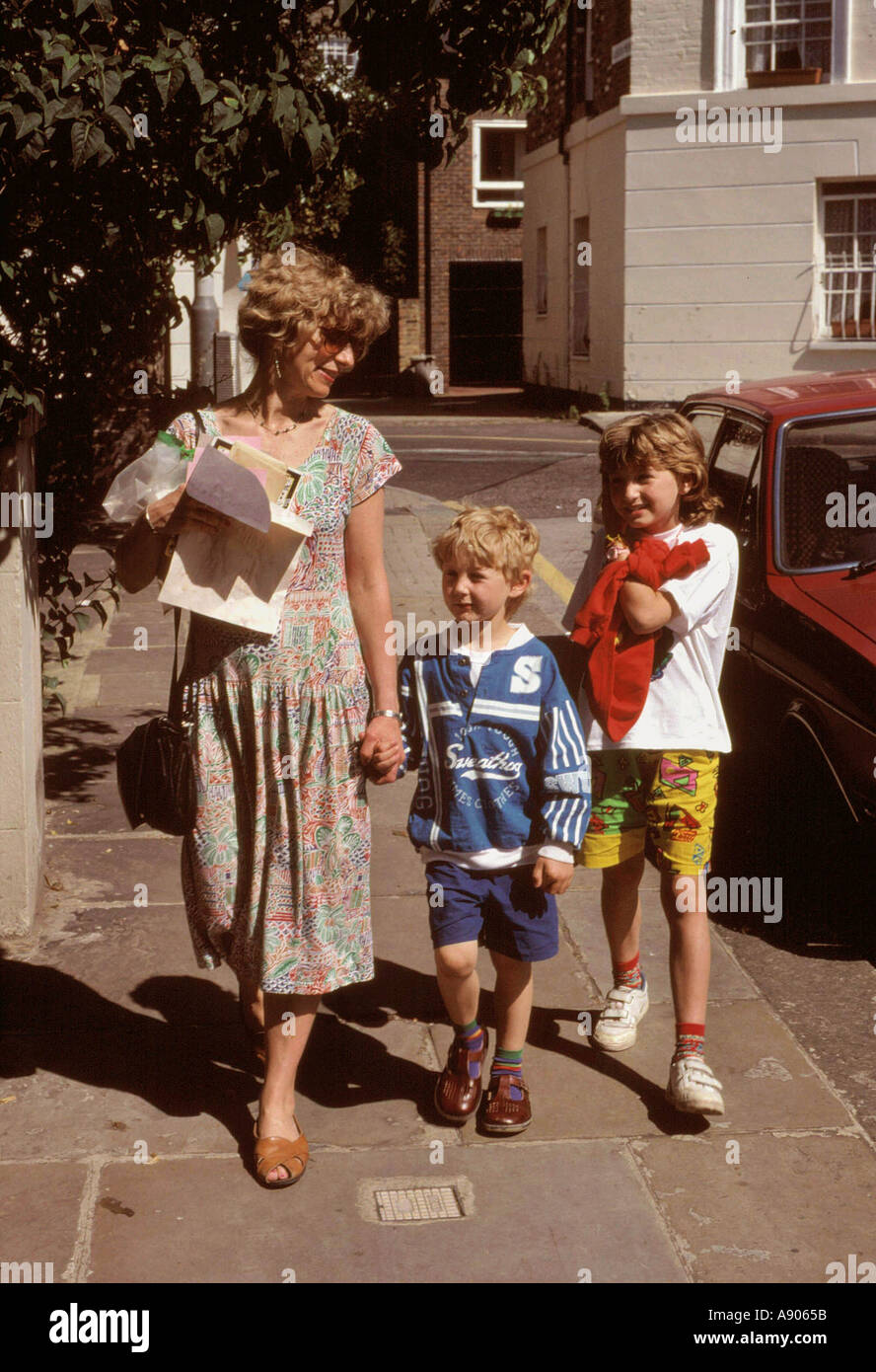 Mother collecting children from school Stock Photo - Alamy