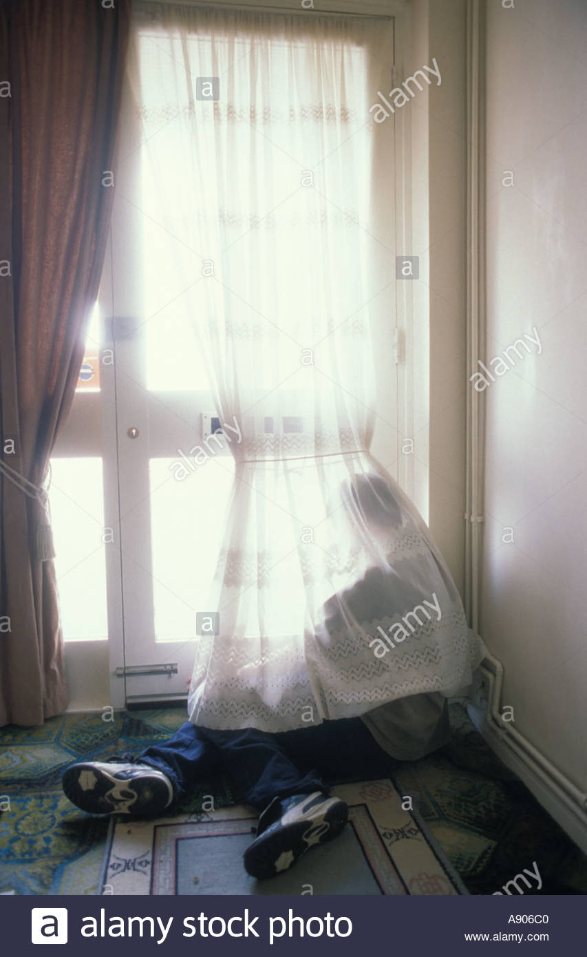 Young Victim Of Child Abuse Boy Sitting On Floor Hidden By Net