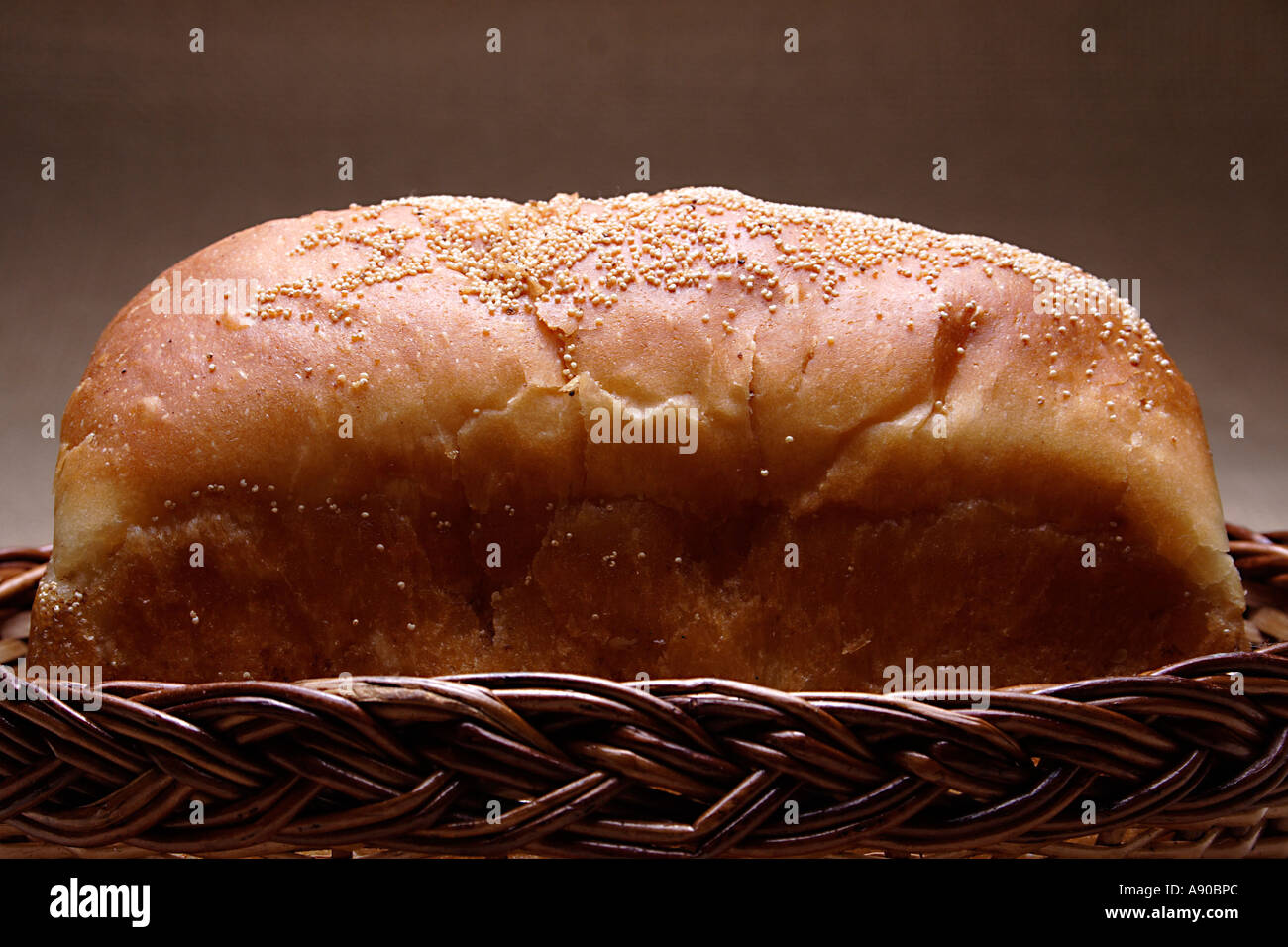 VDA78050 One loaf of white bread with sesame seeds in cane basket Stock