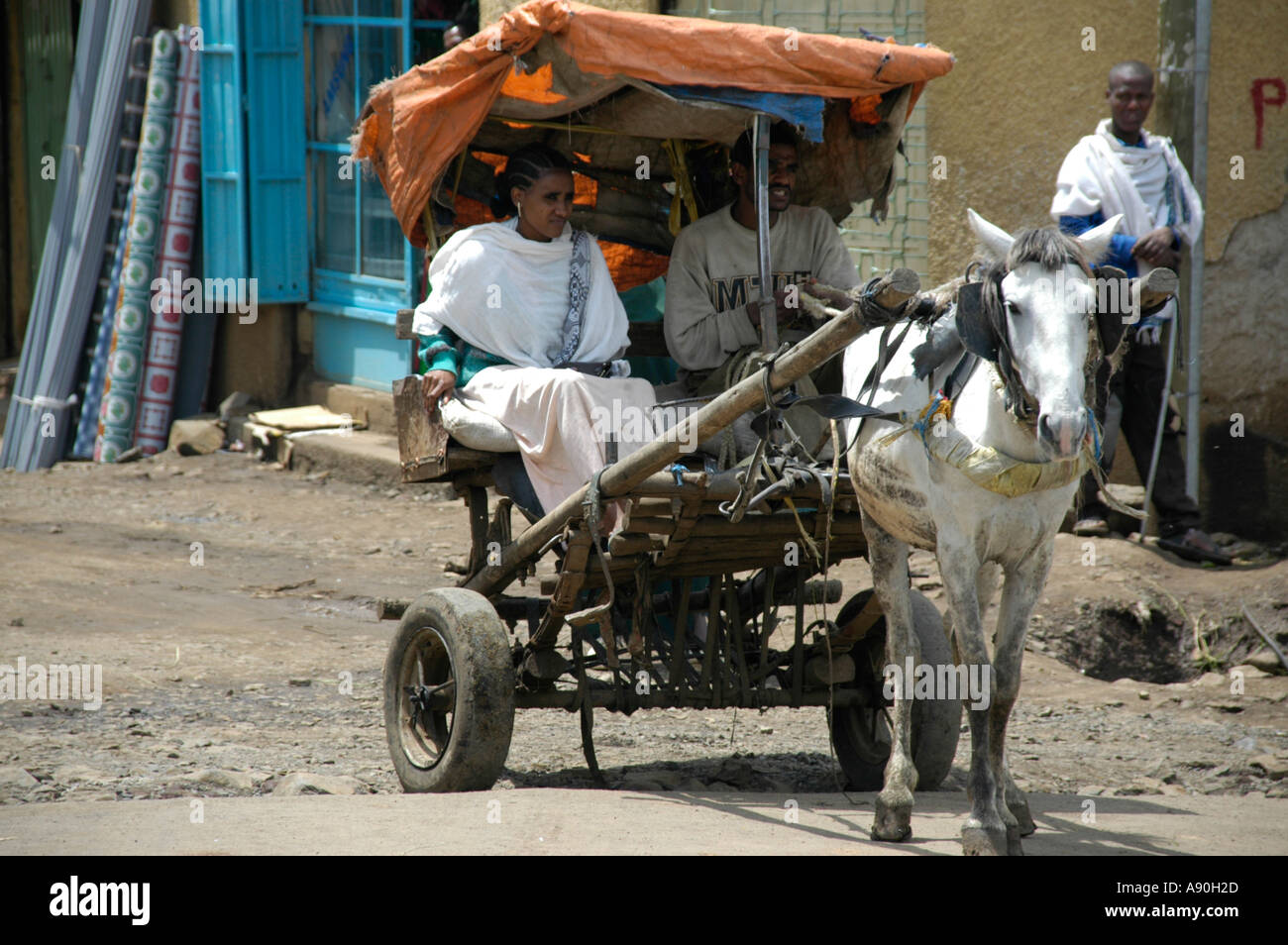 Couple riding in a horse cart in the old town of Gondar Ethiopia Stock