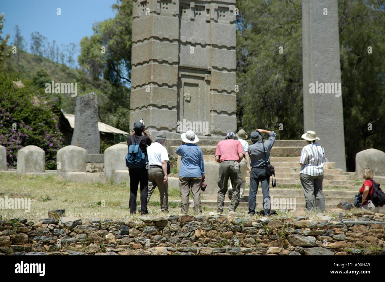 Tourists standing in front of the high standing stele Nr 3 in stele park Aksum Ethiopia Stock Photo