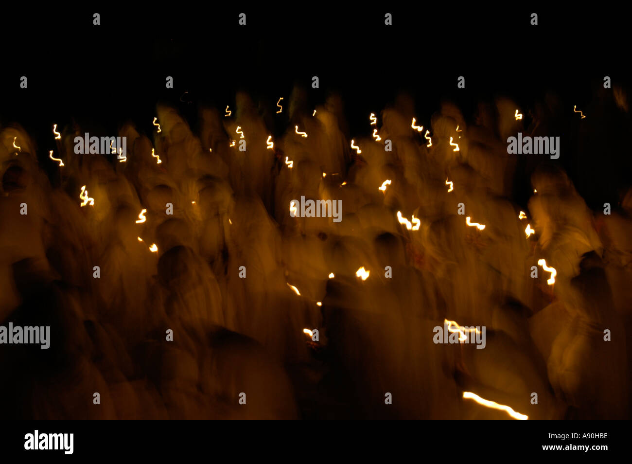 Procession at nighttime of ethiopiean orthodox believers in white capes with candles Aksum Ethiopia Stock Photo