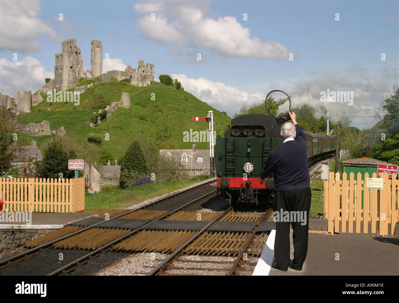 Corfe Castle Station master holds the token for single track operation Stock Photo
