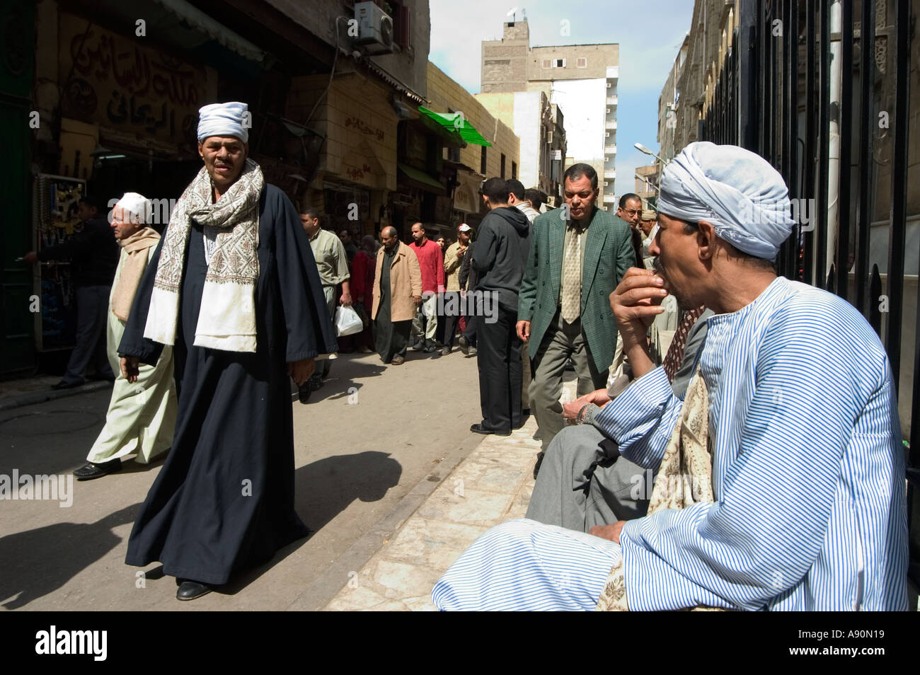 people near mosque at prayer time street scene Islamic Cairo Cairo