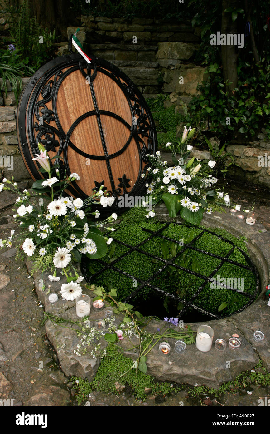 England Somerset Glastonbury Chalice Well with candles and floral offerings Stock Photo