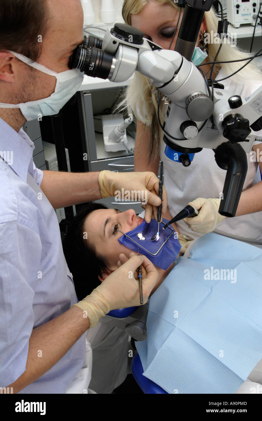Dental treatment with a cofferdam and microscope - Behandlung mit Kofferdamm und Mikroskop beim Zahnarzt Stock Photo