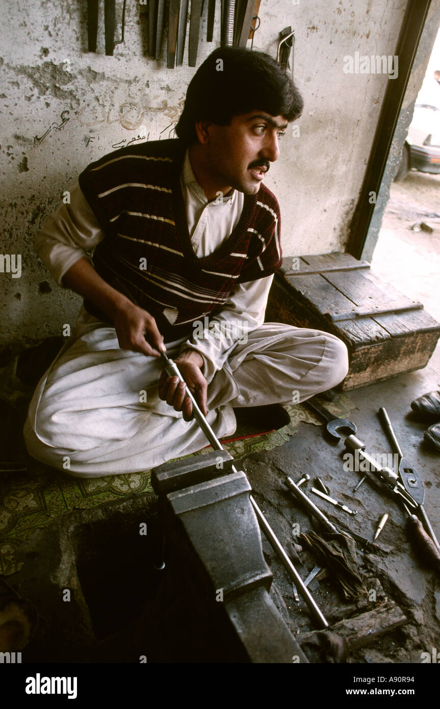 Pakistan NWFP Darra Adam Khel man making rifle barrel Stock Photo