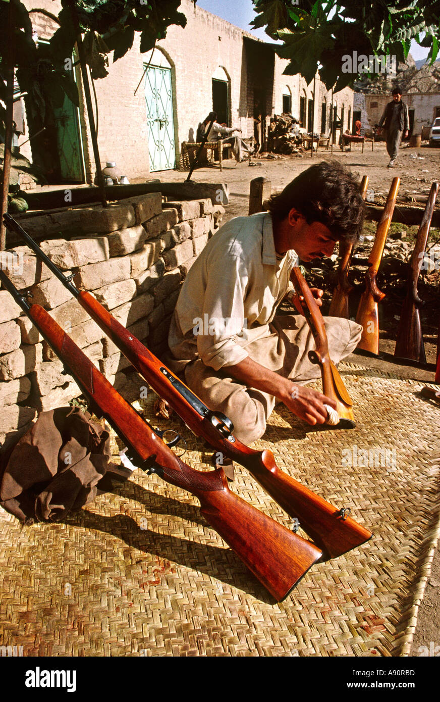 Pakistan NWFP Darra Adam Khel man polishing wooden rifle stocks Stock Photo