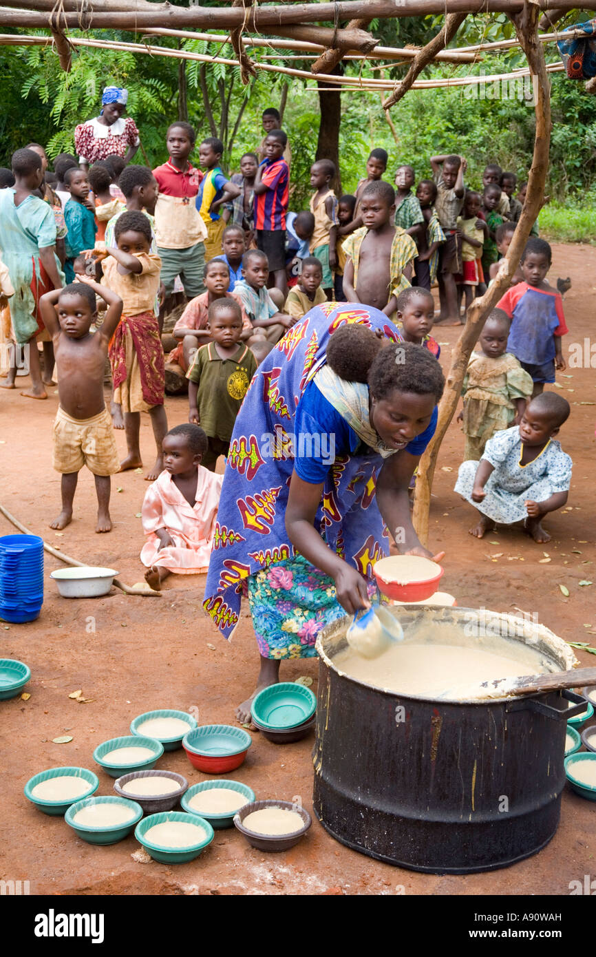 Serving phala to hungry children as part of the Joseph Project feeding programme in the village of Kendekeza, Malawi, Africa Stock Photo