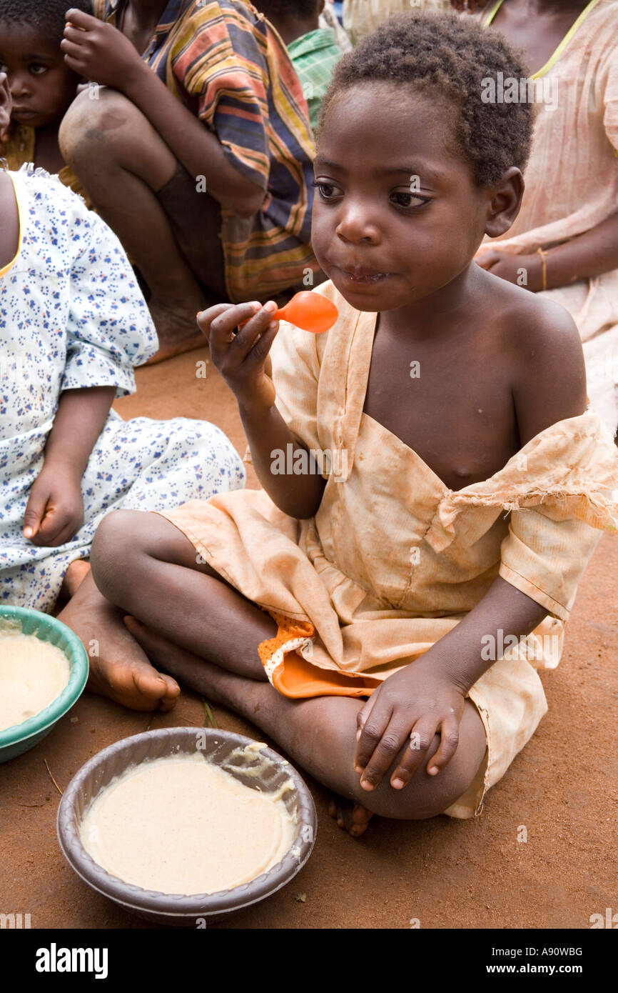 Children eating phala (maize porridge) as part of the Joseph Project feeding programme in the village of Kendekeza Malawi Africa Stock Photo