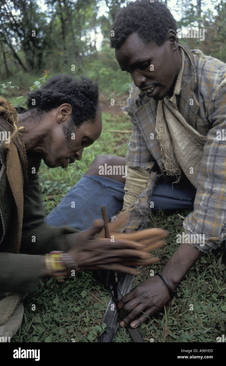 Ogiek hunters start a fire by hand in the Mau forest Kenya Stock Photo