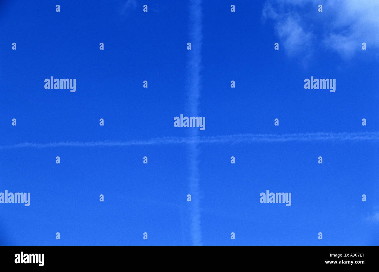 Passenger aircraft vapour trails in the sky over Suffolk, UK. Stock Photo