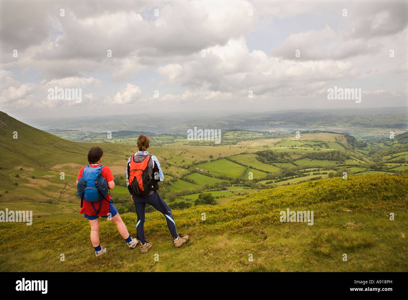 Two women hikers looking at the view from Hay Bluff Black Mountains Wales UK Stock Photo