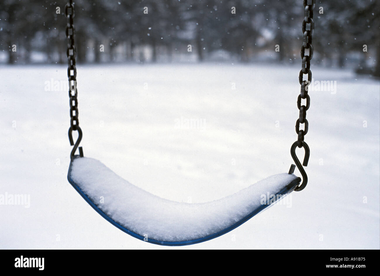 Empty swing in winter Stock Photo