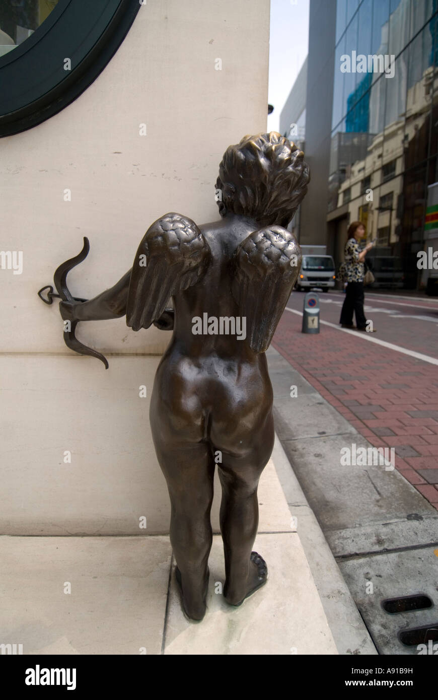 Statue of cupid on street corner outside jewellery shop in Ginza Tokyo Japan 2007 Stock Photo
