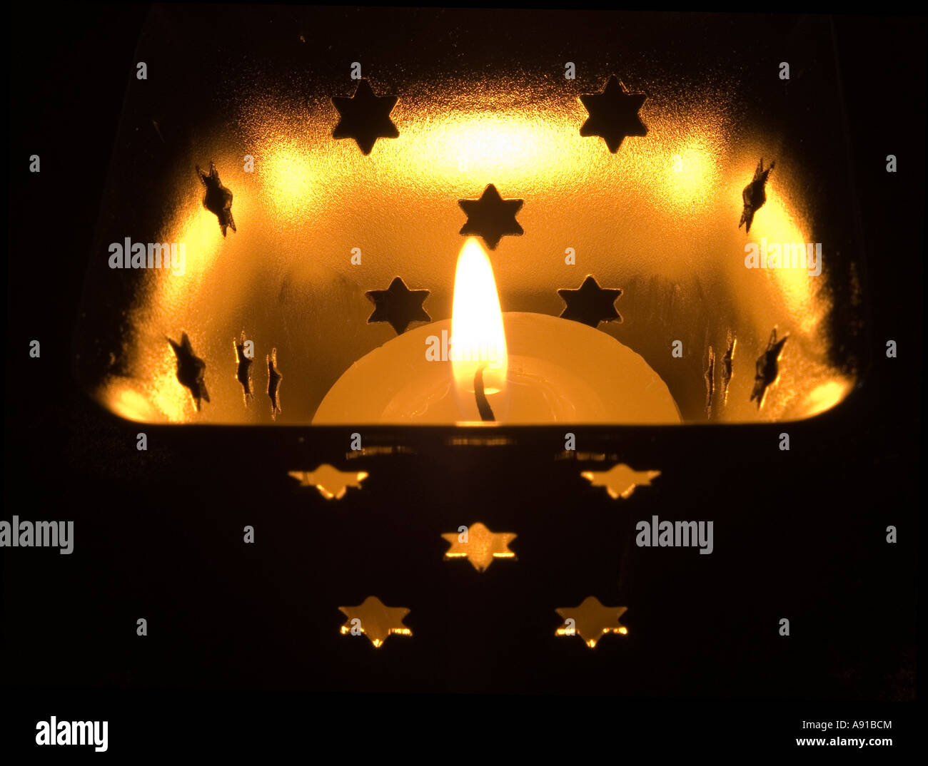 Single tea light flame in a candle pot Stock Photo Alamy