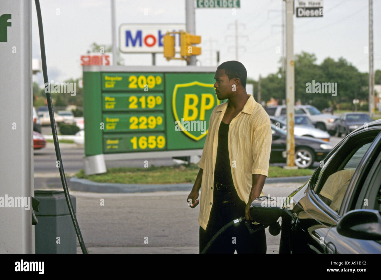 Royal Oak Township Michigan A man pumps gasoline at a BP gas station with prices above 2 00 a gallon Stock Photo
