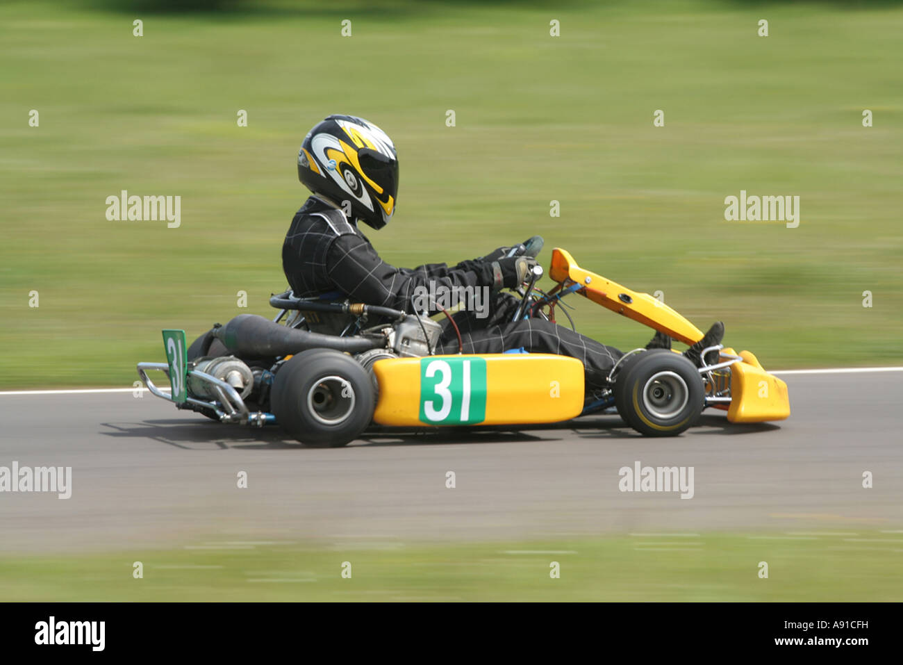 The side view of a speeding yellow gearbox go kart Stock Photo Alamy