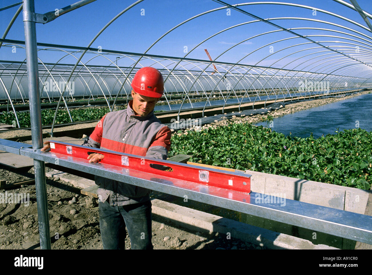 Construction worker using a level at a fish hatchery in Caldwell, Idaho. Stock Photo