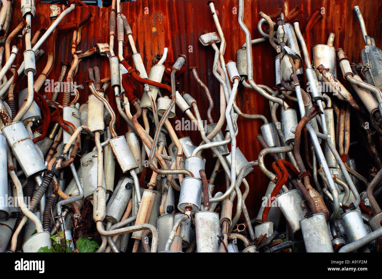 Car Exhausts in a scrap yard Stock Photo Alamy