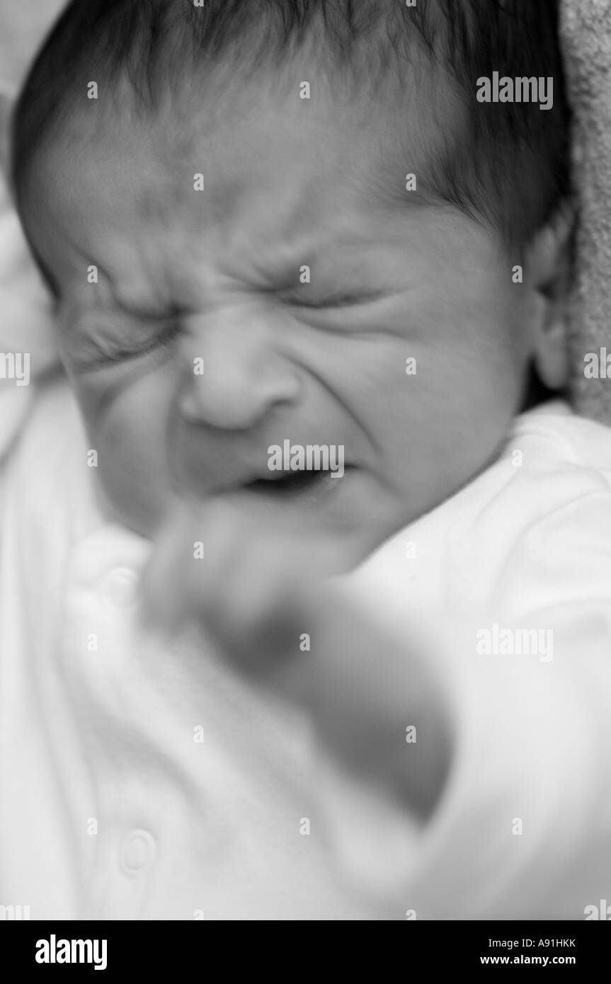 Annoyed newborn baby boy Stock Photo