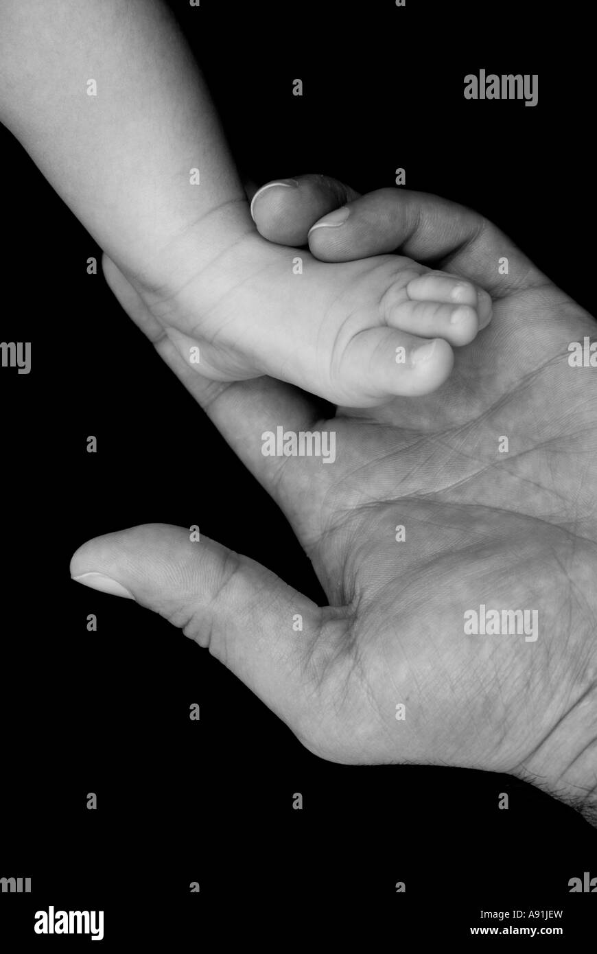 Man holding newborn foot Stock Photo