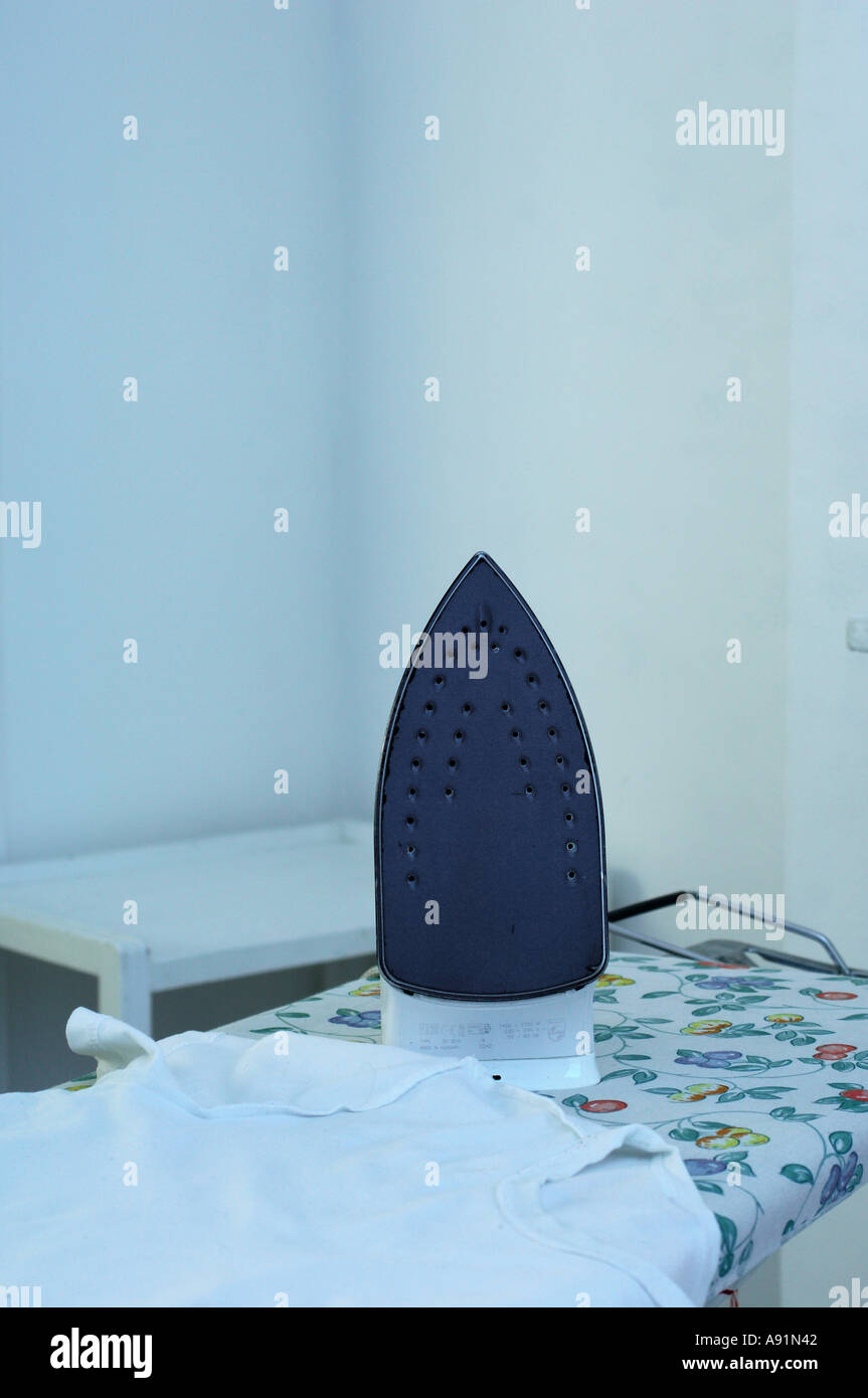Iron on an Ironing Board Stock Photo Alamy