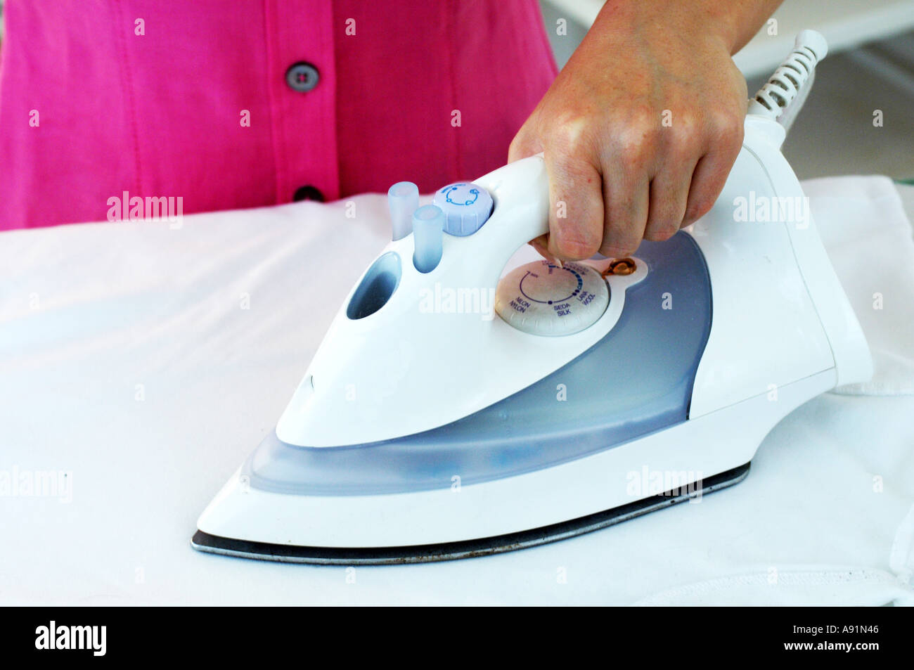 Iron on an Ironing Board Stock Photo Alamy