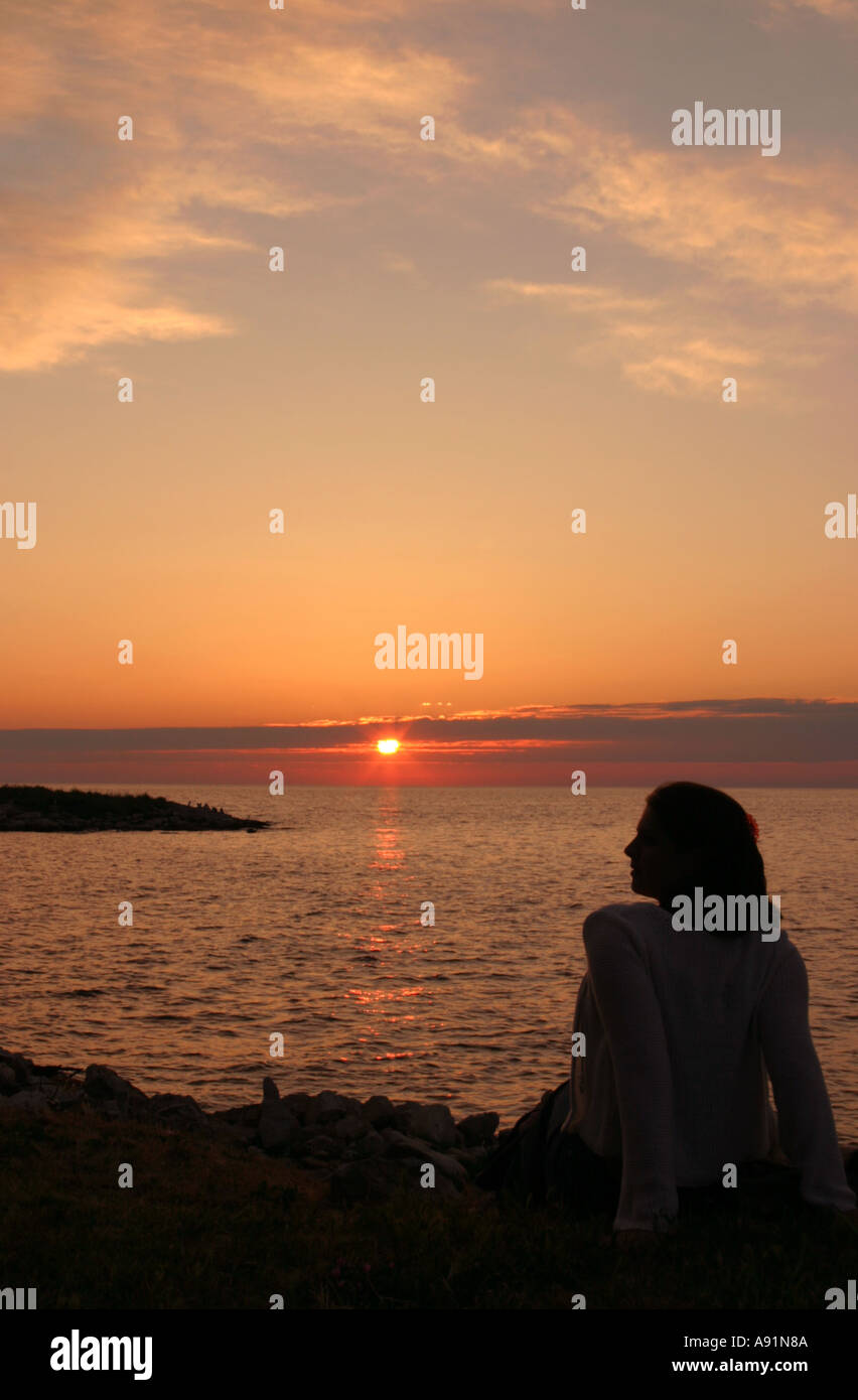 Silhouette of girl watching sunset Stock Photo - Alamy