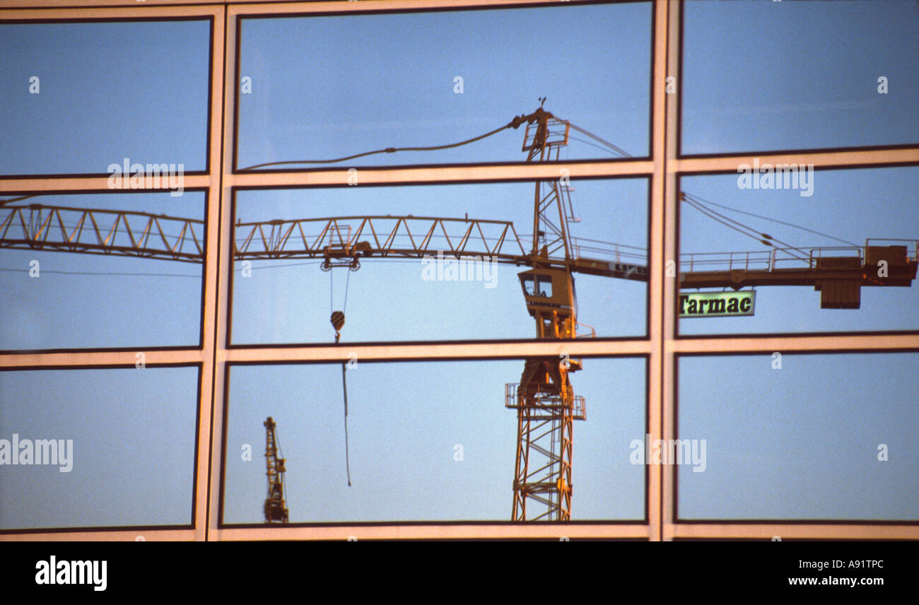 PICTURE CREDIT DOUG BLANE Tarmac crane on building site reflected in the glass building at Central Milton Keynes shopping centre Stock Photo
