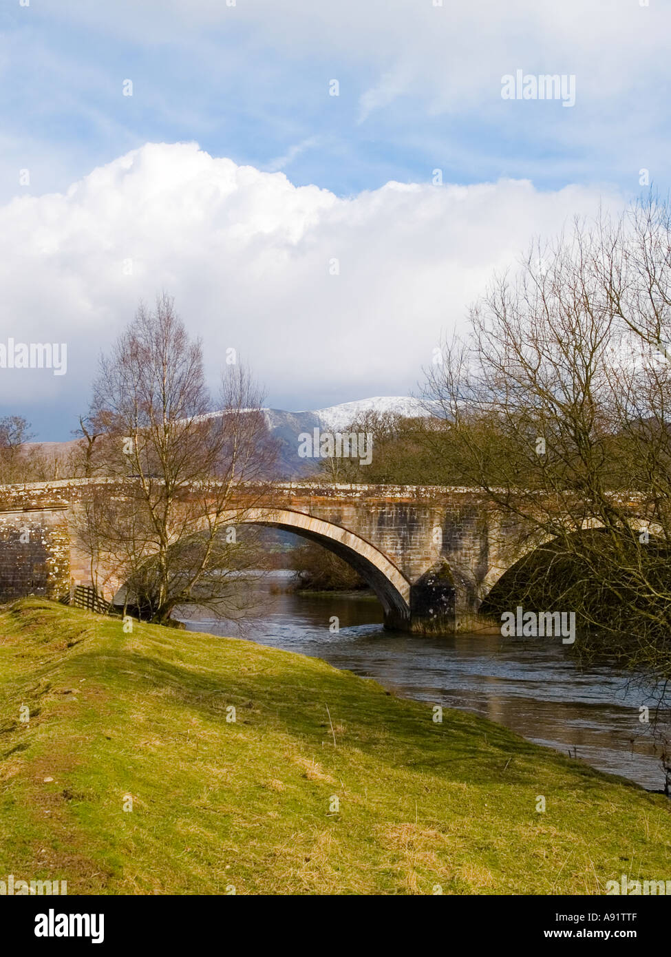 Ouse Bridge at the northern end of Lake Bassenthwaite, Cumbria, UK, with Skiddaw mountain in the distance Stock Photo