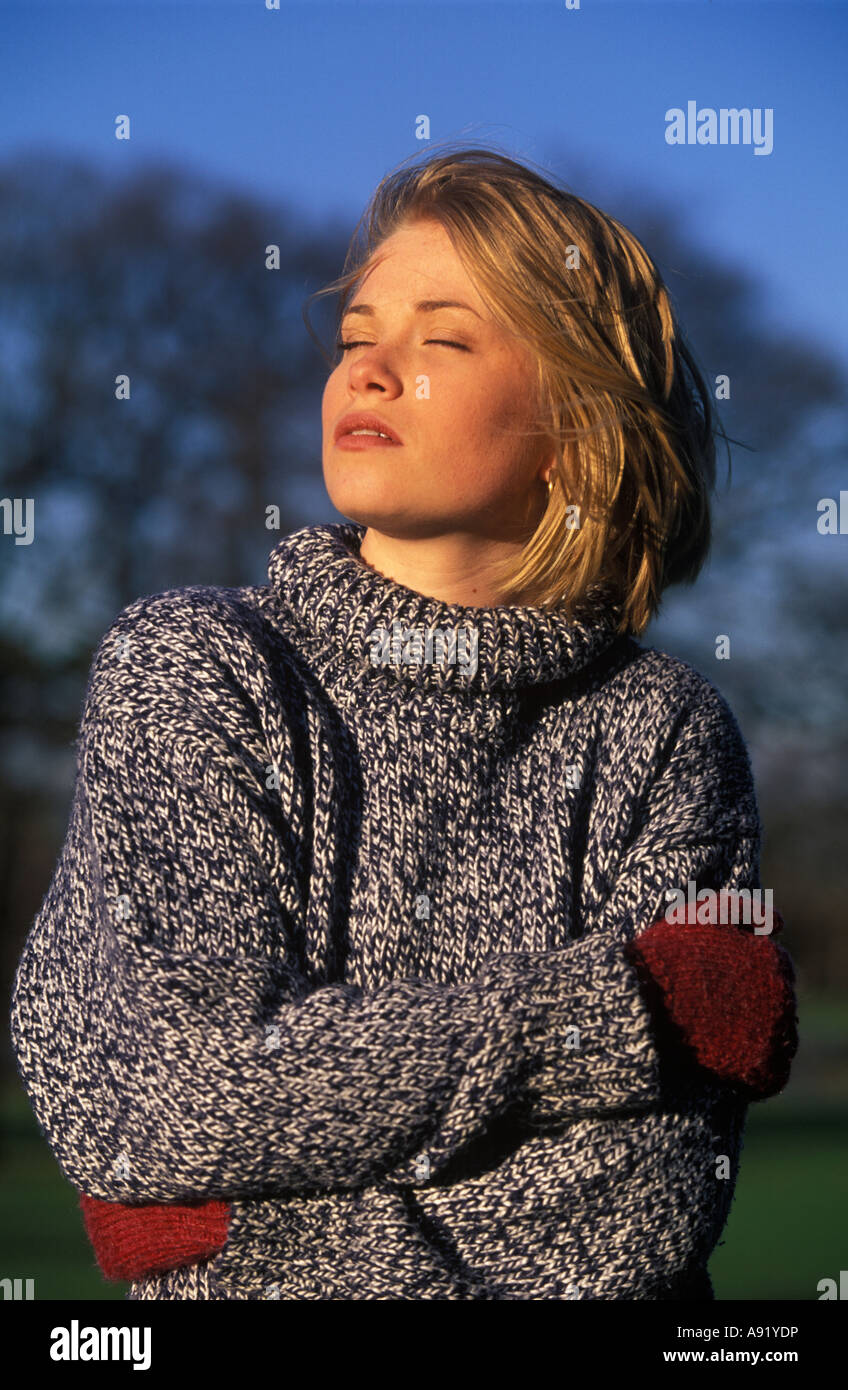 woman enjoying some winter sunshine on her face Stock Photo