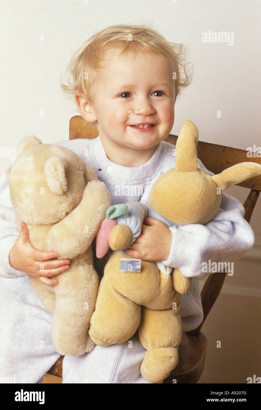 toddler cuddling his soft toys Stock Photo Alamy