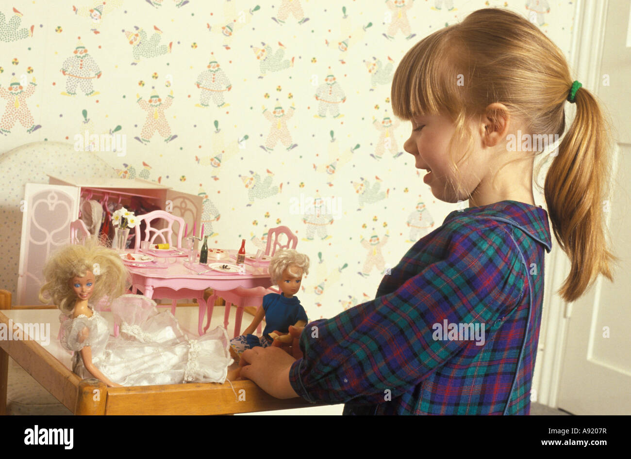 little girls playing with barbie dolls
