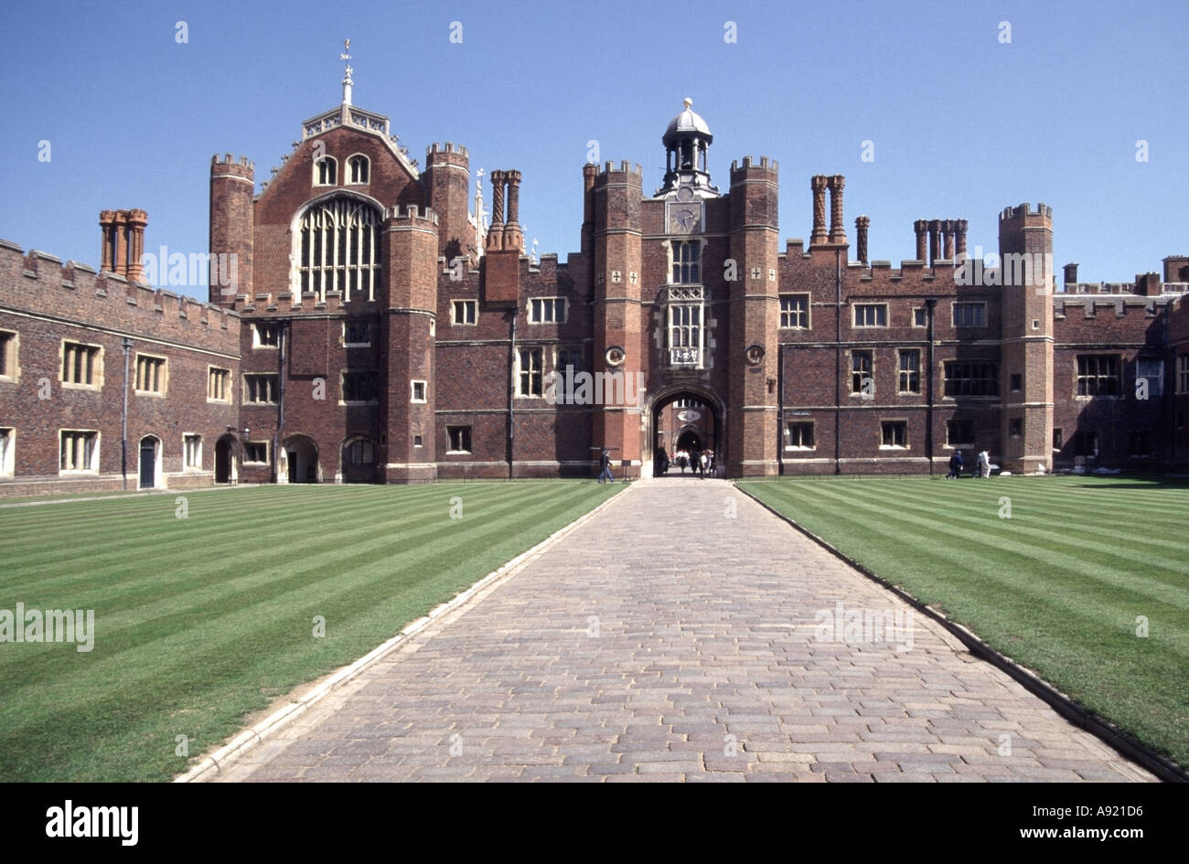Hampton Court Palace & historical Base courtyard and lawn stripes part of the major tourist attraction at Richmond upon Thames London England UK Stock Photo