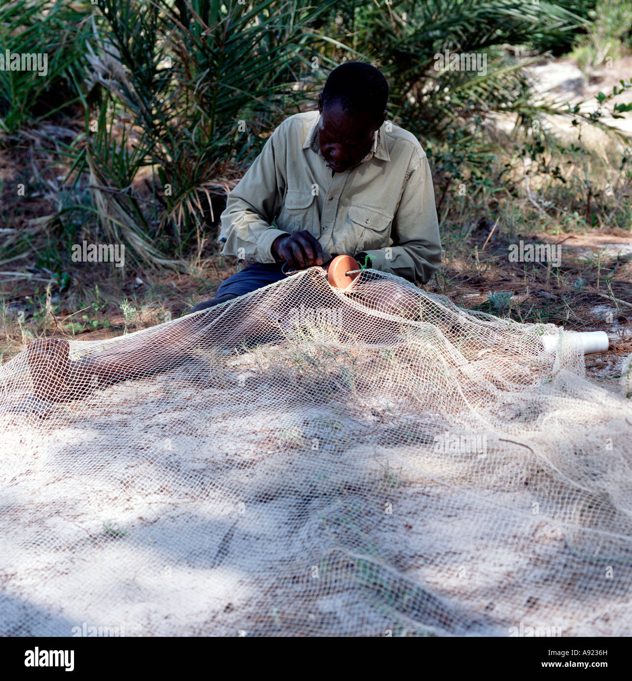Mozambican sewing fishing net Stock Photo