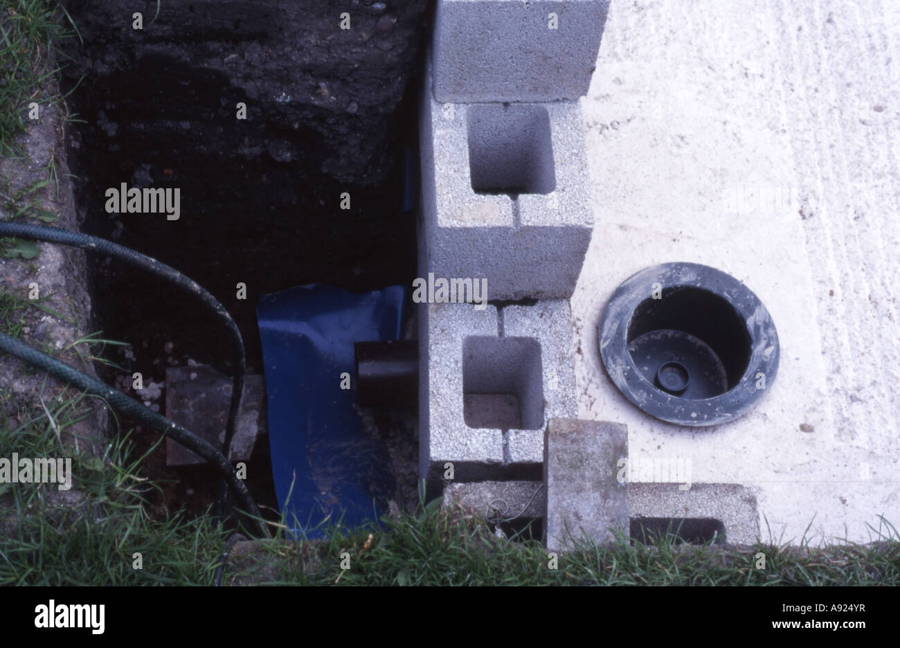 Koi pond construction looking down on bottom drain and outlet, UK Stock